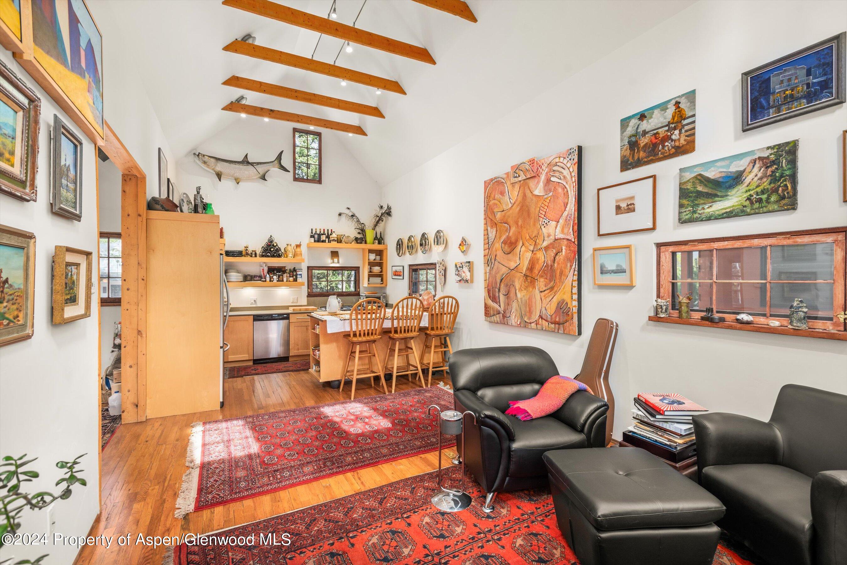 308 Park Avenue Aspen, CO 81611 - Photo 4 of 26 a living room with furniture a rug and a wall painting