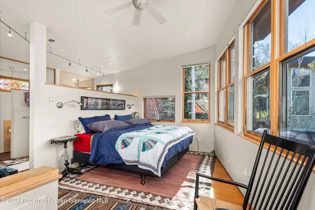 a bedroom with a bed and a window