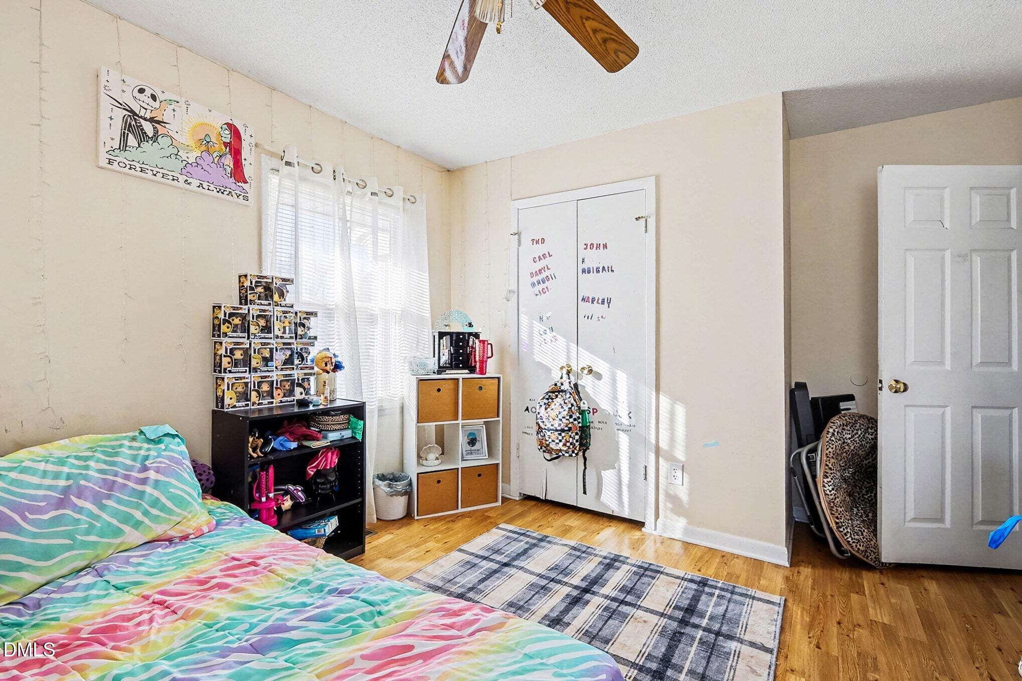 104 Rosebud Street Spring Lake, NC 28390 - Photo 16 of 29 a bedroom with a bed and a wooden floor