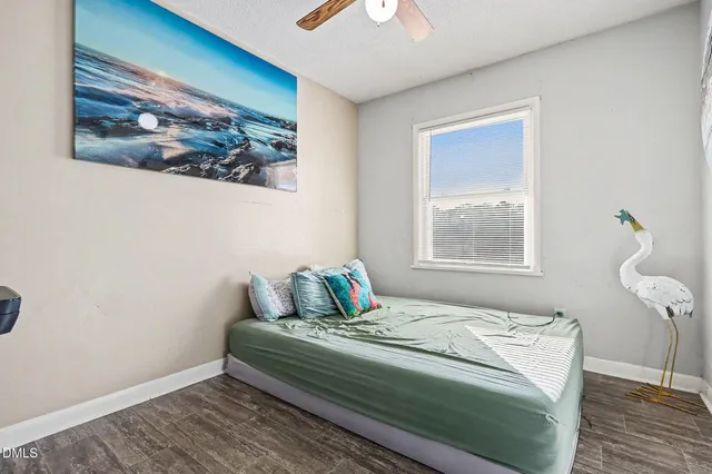 a bedroom with bed and a window