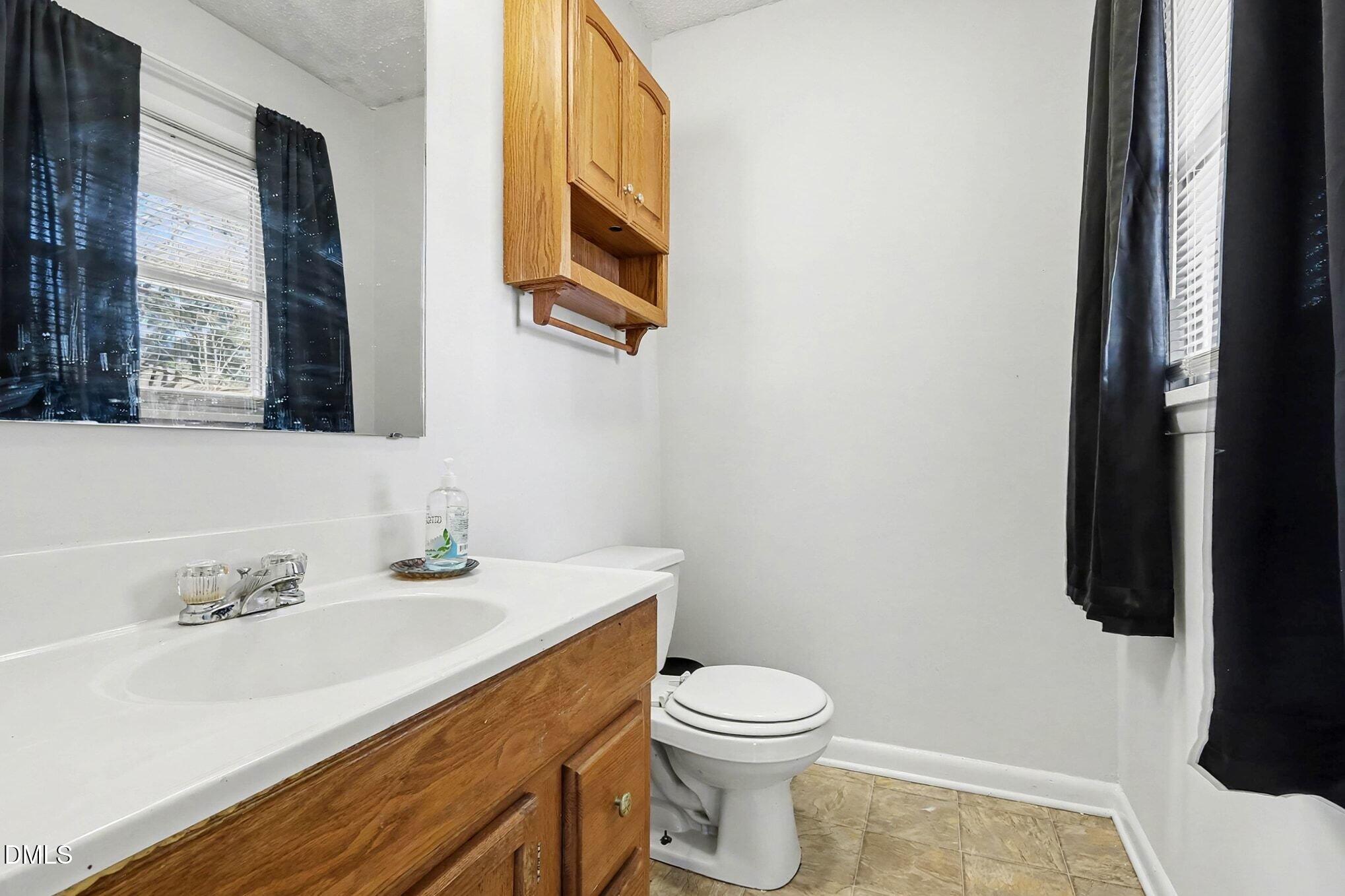 104 Rosebud Street Spring Lake, NC 28390 - Photo 18 of 29 a bathroom with a sink toilet and mirror