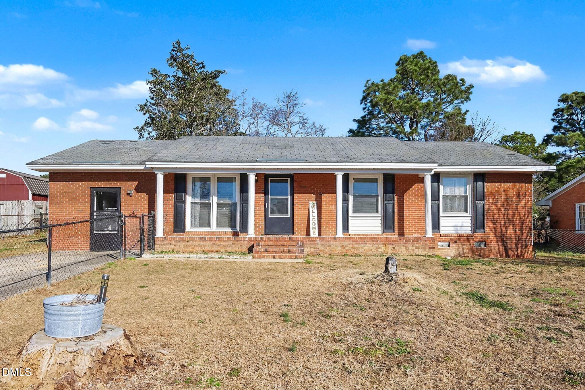 104 Rosebud Street Spring Lake, NC 28390 - Photo 2 of 29 a front view of a house with a yard