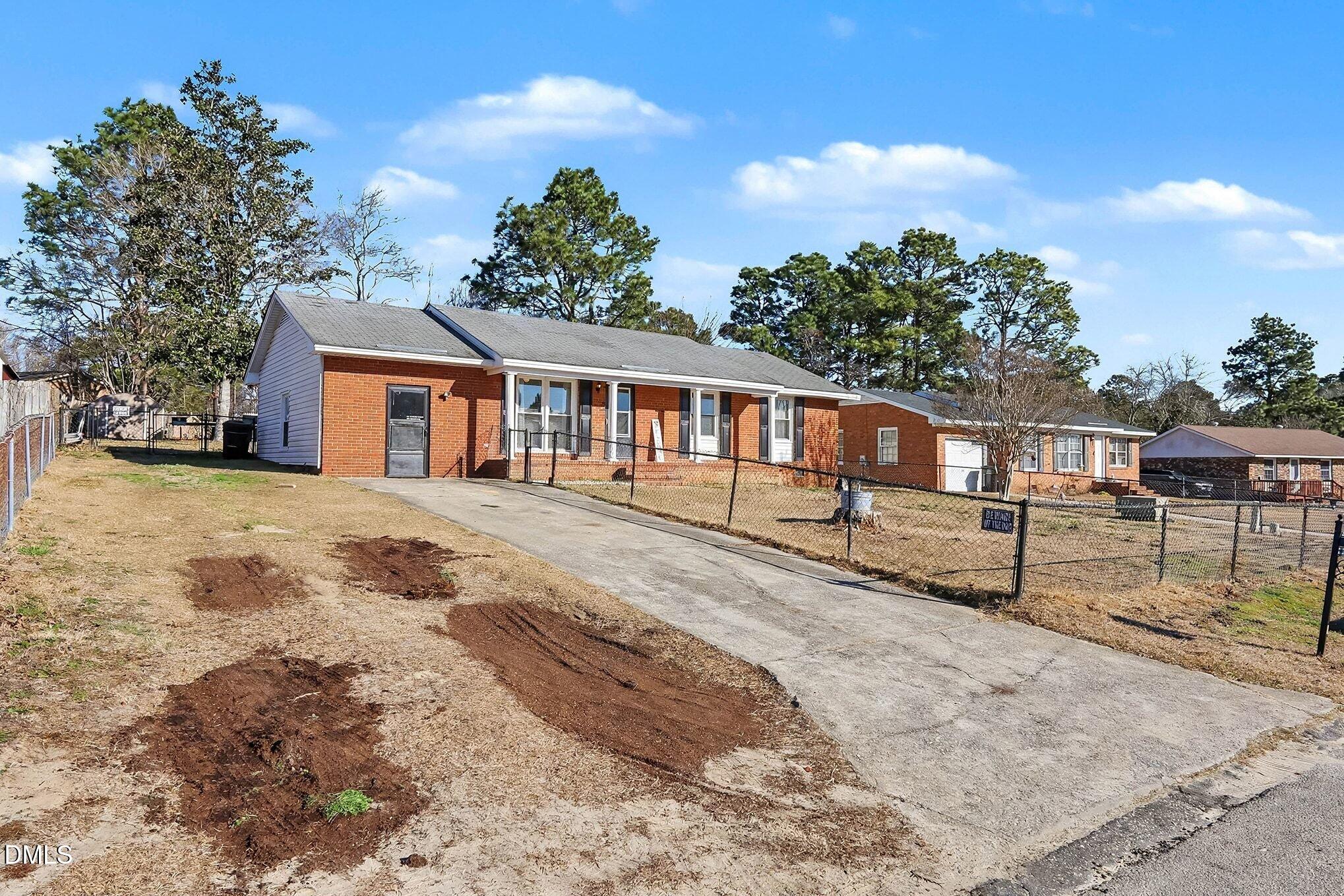 104 Rosebud Street Spring Lake, NC 28390 - Photo 3 of 29 a view of a house with wooden fence