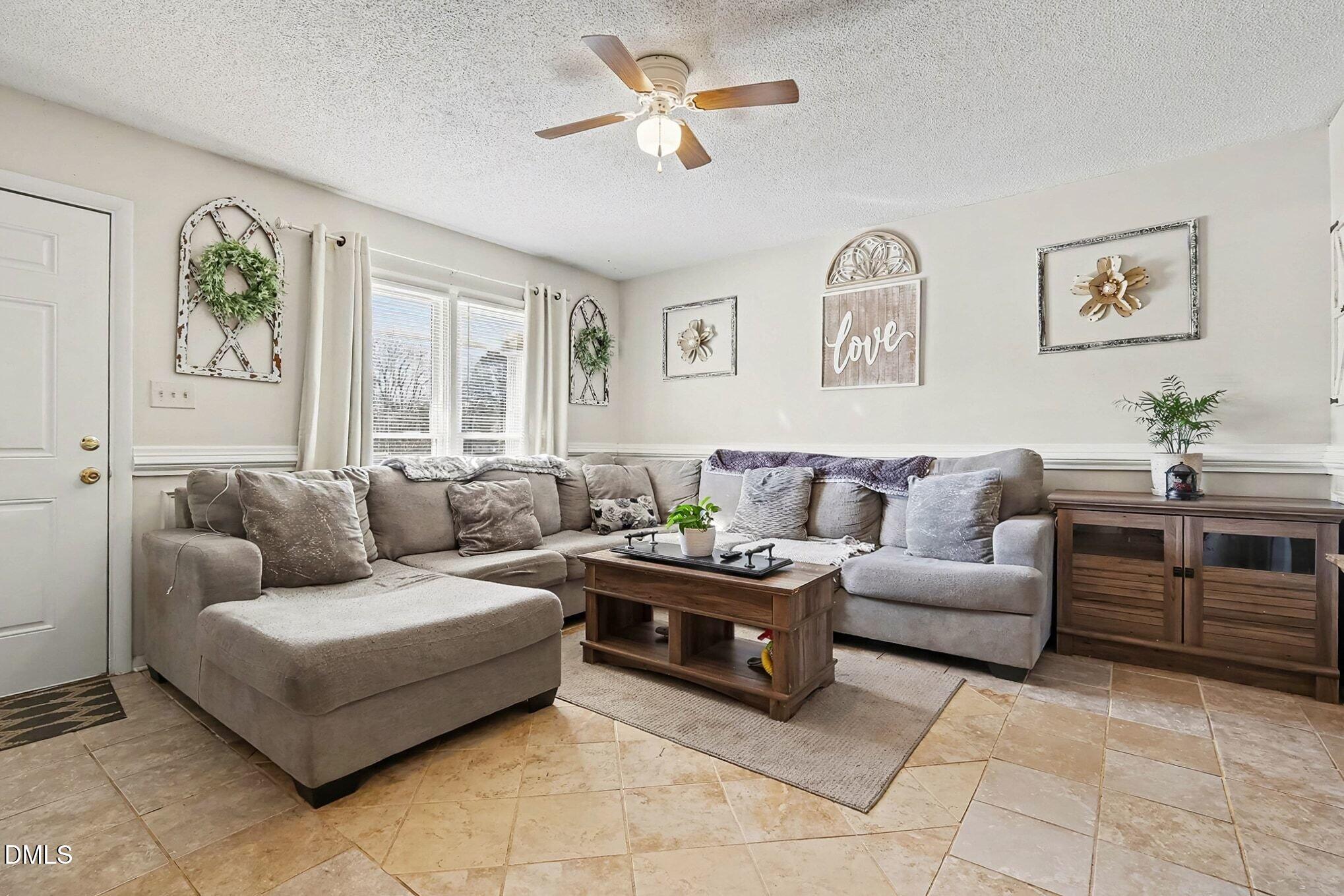 104 Rosebud Street Spring Lake, NC 28390 - Photo 6 of 29 a living room with furniture ceiling fan and a window