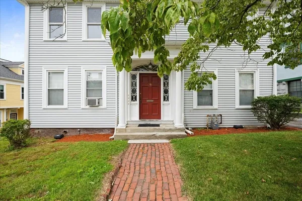 a front view of a house with garden