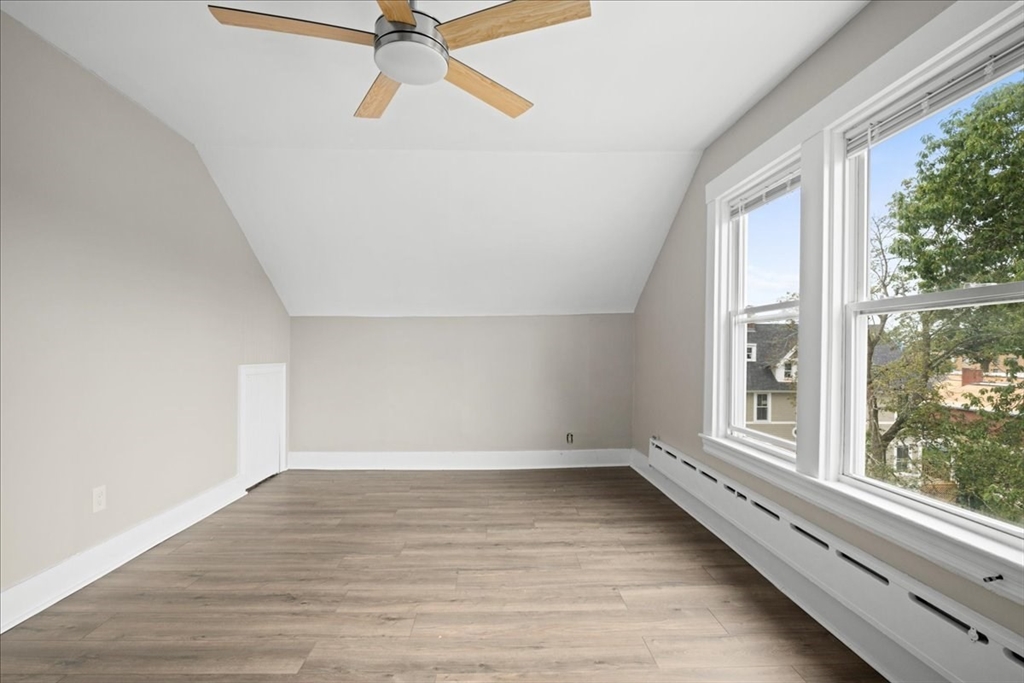 36 Cedar Street, Unit 2A Worcester, MA 01609 - Photo 11 of 26 a view of an empty room with a window and wooden floor