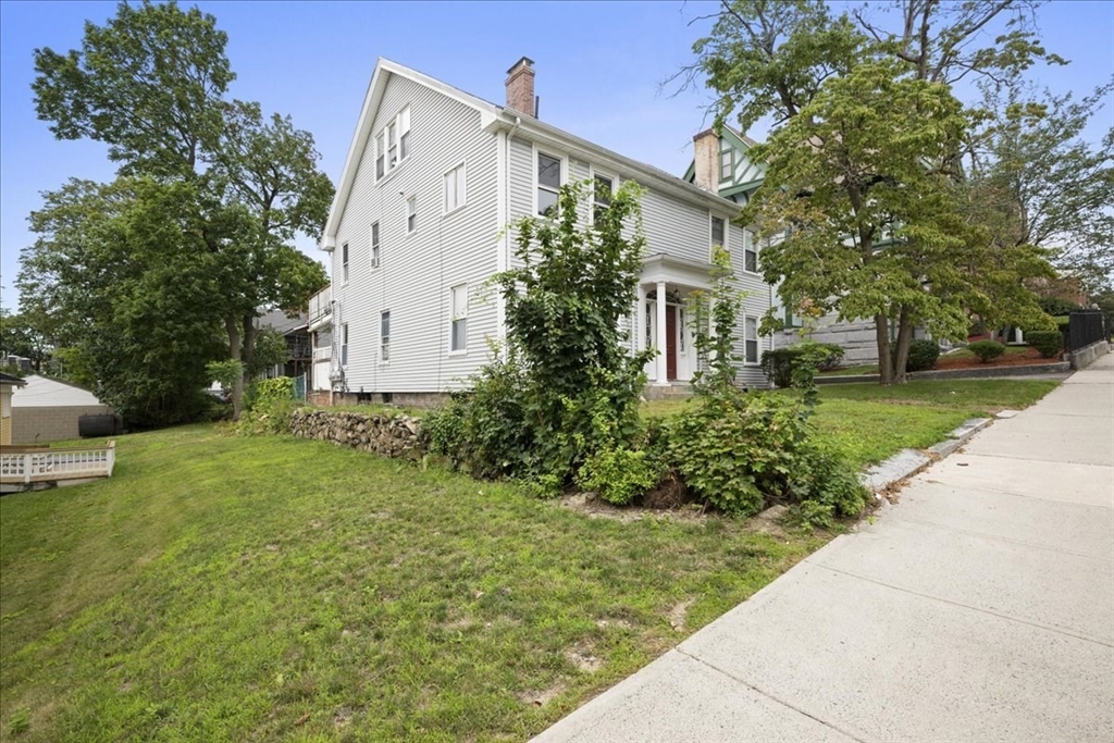 36 Cedar Street, Unit 2A Worcester, MA 01609 - Photo 18 of 26 a view of a white house with a yard and large tree