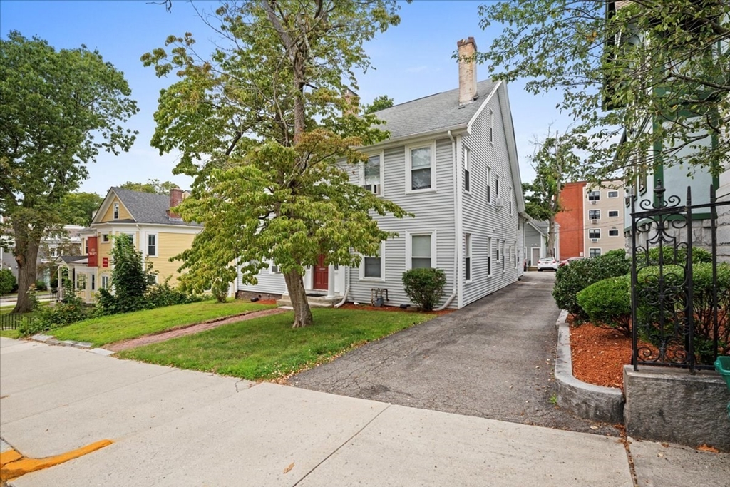 36 Cedar Street, Unit 2A Worcester, MA 01609 - Photo 20 of 26 a view of a white house with a yard and plants