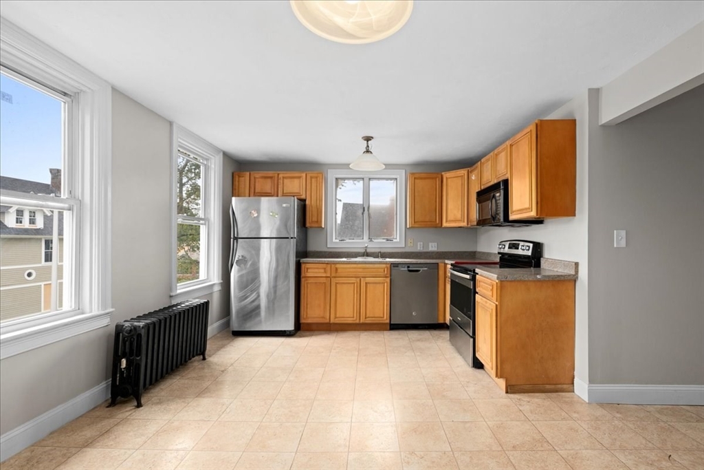 36 Cedar Street, Unit 2A Worcester, MA 01609 - Photo 2 of 26 a kitchen with stainless steel appliances granite countertop a refrigerator sink and cabinets