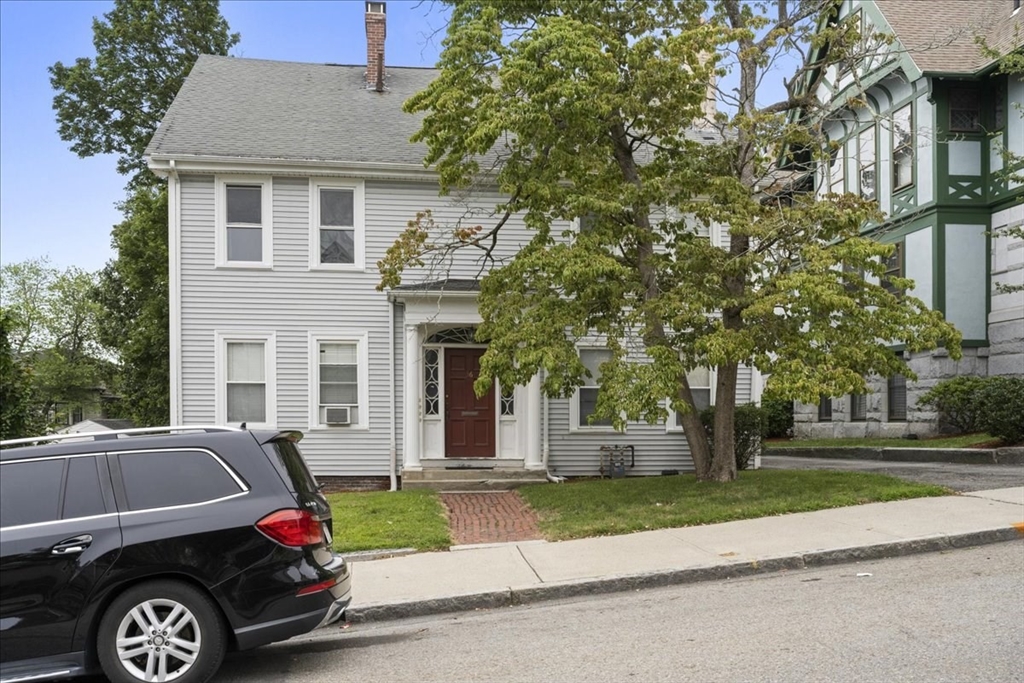 36 Cedar Street, Unit 2A Worcester, MA 01609 - Photo 23 of 26 a car parked in front of a white house