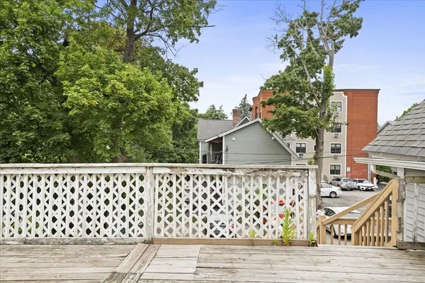 a view of a wooden deck with a yard