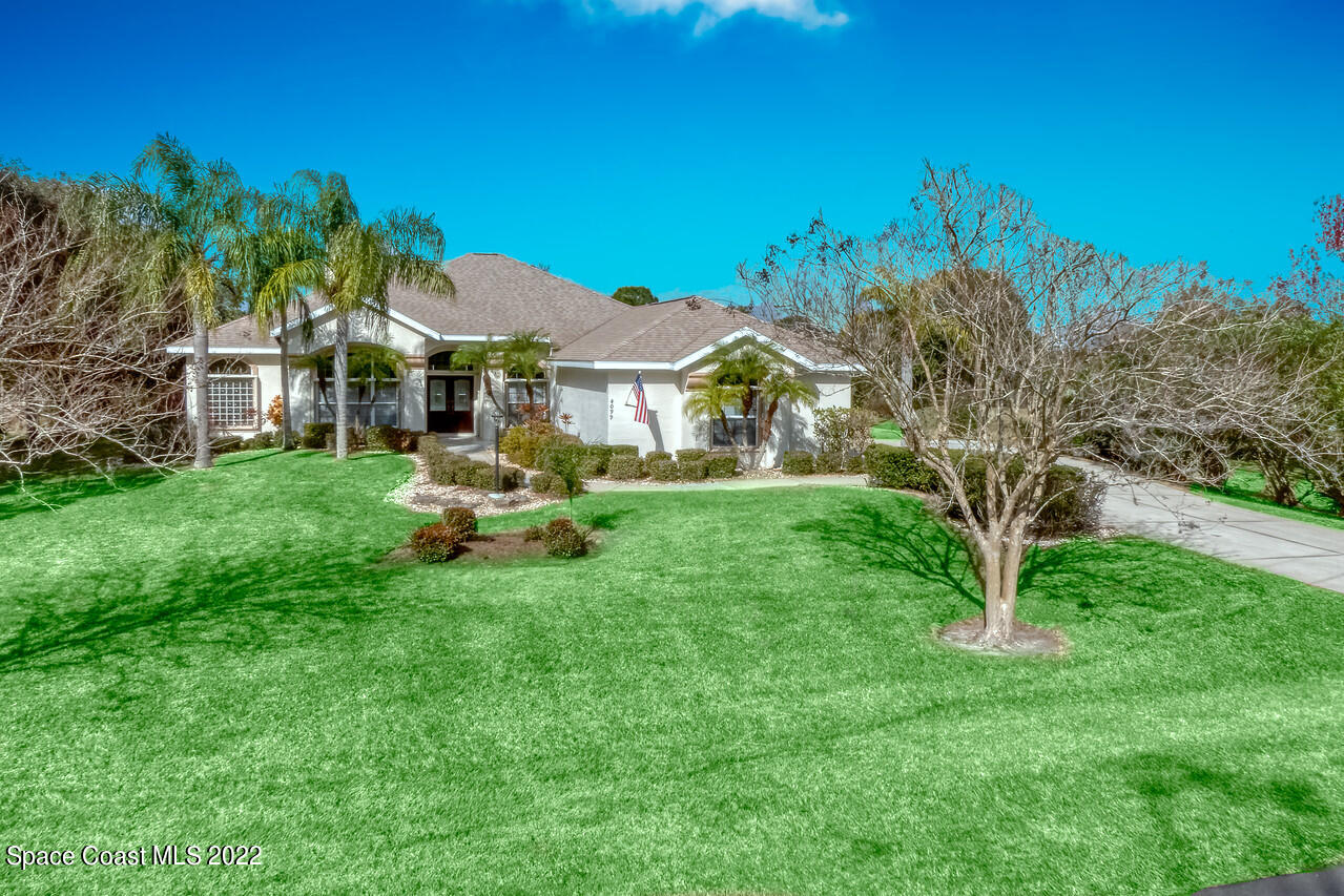4099 Sparrow Hawk Road Melbourne, FL 32934 - Photo 17 of 48 a front view of a house with garden