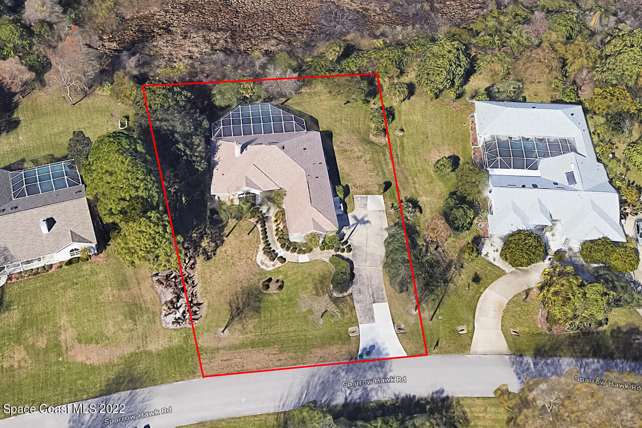 4099 Sparrow Hawk Road Melbourne, FL 32934 - Photo 3 of 48 an aerial view of a house with a yard