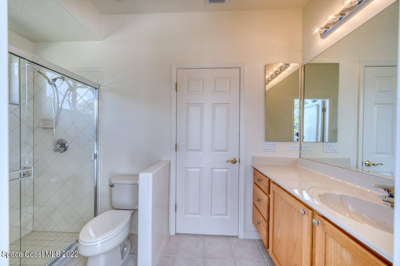 4099 Sparrow Hawk Road Melbourne, FL 32934 - Photo 35 of 48 a bathroom with a granite countertop sink toilet and shower