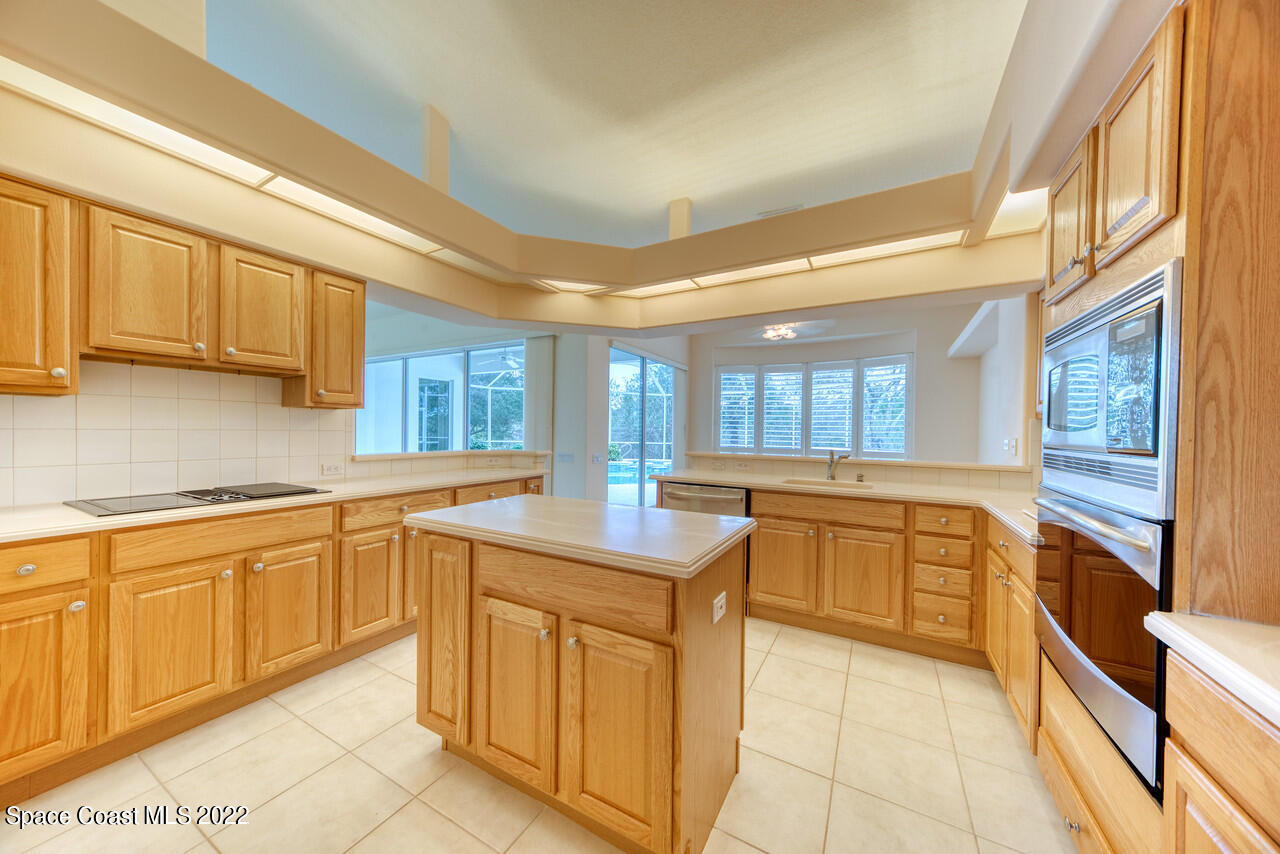 4099 Sparrow Hawk Road Melbourne, FL 32934 - Photo 7 of 48 a kitchen with cabinets and appliances