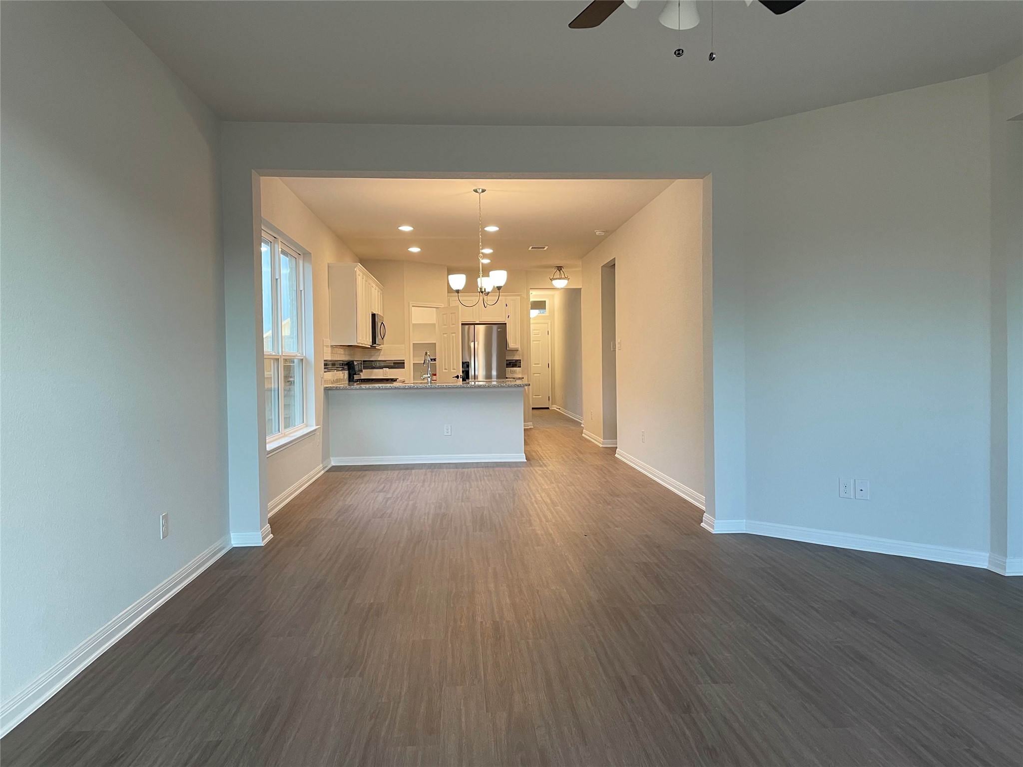 3908 Birdwatch Loop, Unit 56 Pflugerville, TX 78660 - Photo 26 of 30 a view of a hallway with wooden floor