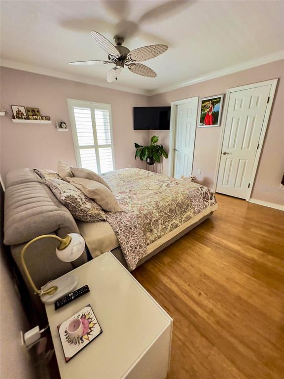 8911 Blind Pass Road, Unit 220 St. Pete Beach, FL 33706 - Photo 26 of 67 a bedroom with a bed and a dresser in it