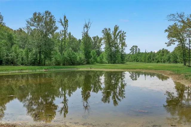 a view of a house with a yard from a lake view