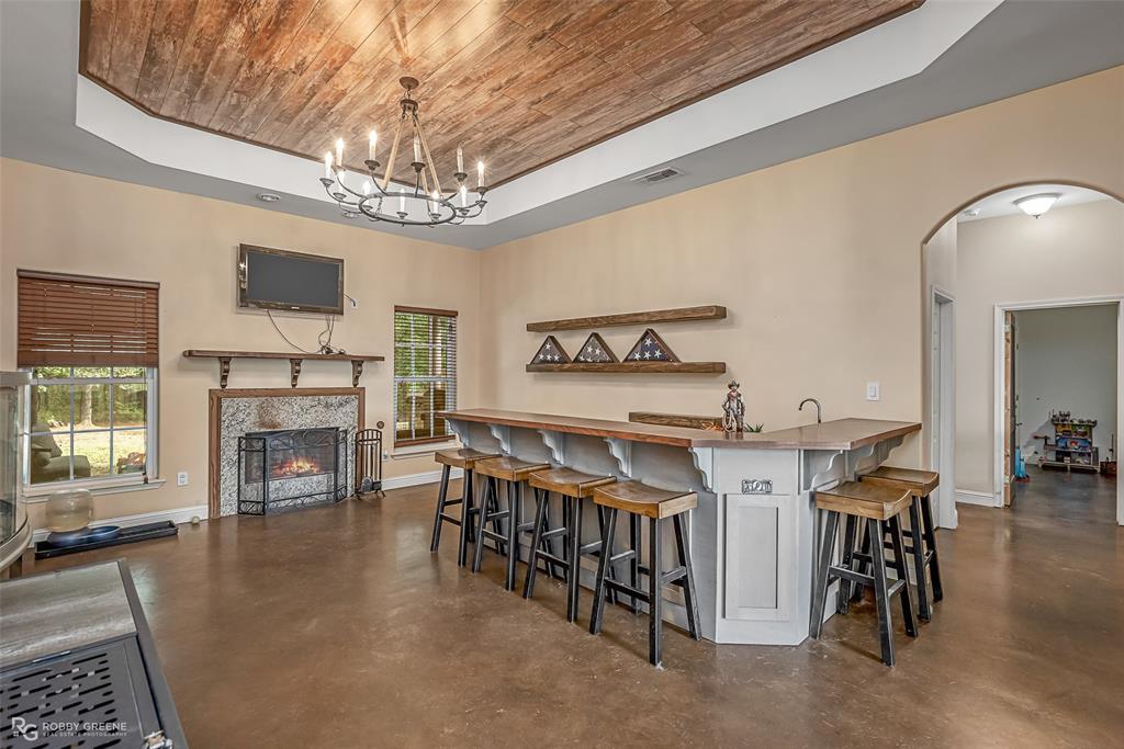 495 John Gloster, LA 71030 - Photo 17 of 40 a living room with furniture a fireplace and a chandelier