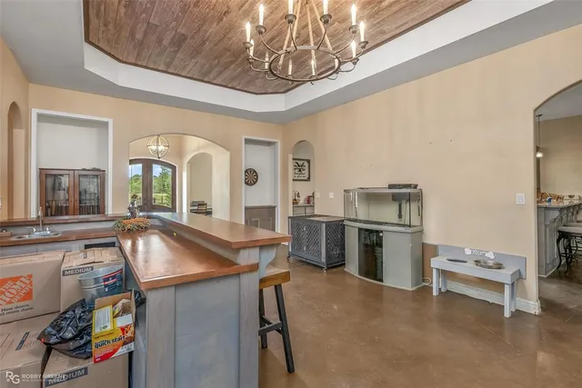 a kitchen with stainless steel appliances granite countertop a stove top oven a sink a counter space and cabinets