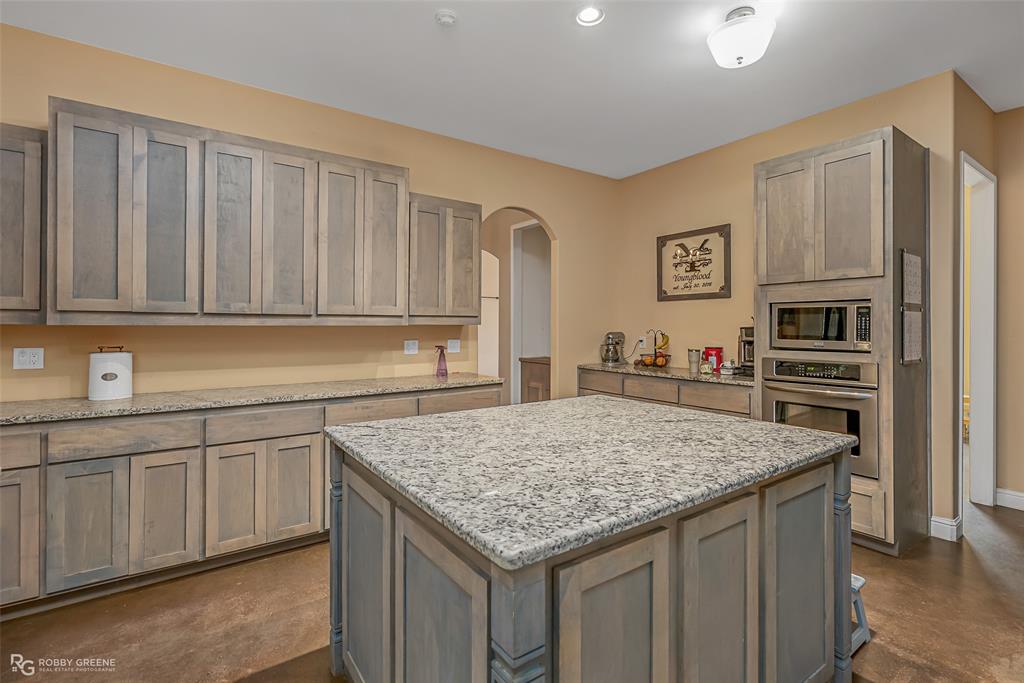 495 John Gloster, LA 71030 - Photo 21 of 40 a kitchen with granite countertop a sink stove and refrigerator