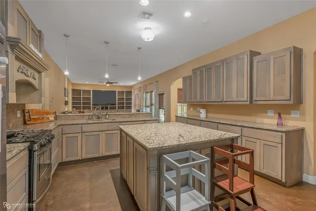 a kitchen with stainless steel appliances granite countertop a stove oven and a sink