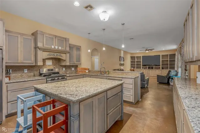 a kitchen with stainless steel appliances granite countertop a refrigerator and a sink