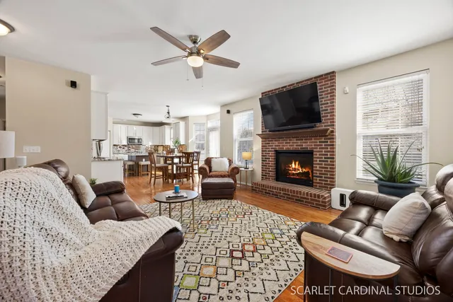 a living room with furniture a fireplace and a flat screen tv