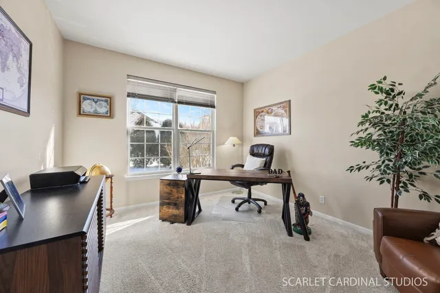 a view of a workspace with furniture and a window
