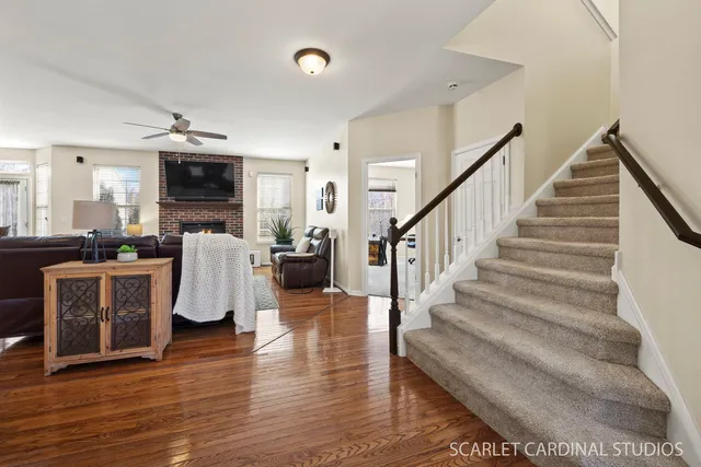 a living room with furniture a flat screen tv and kitchen view