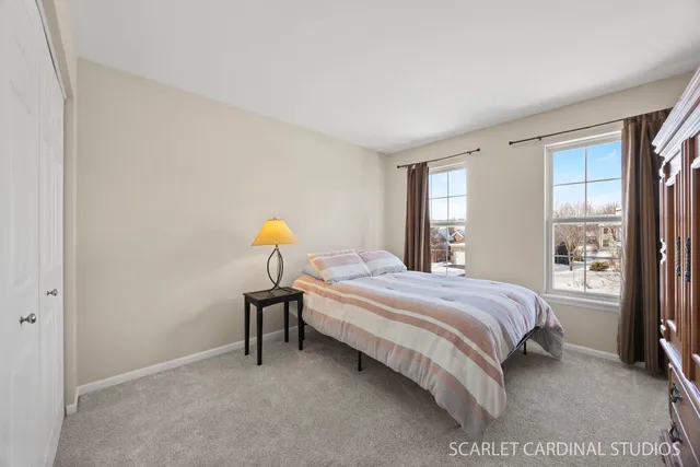 a bedroom with a bed lamp and window