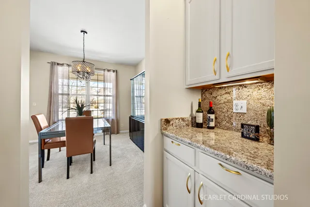 a kitchen with granite countertop sink and cabinets