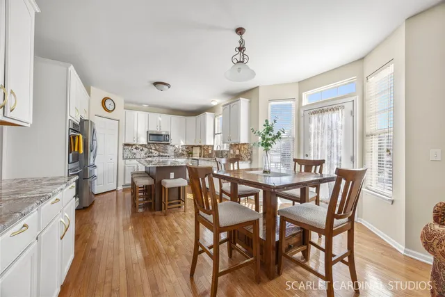 a view of a dining room with furniture and wooden floor