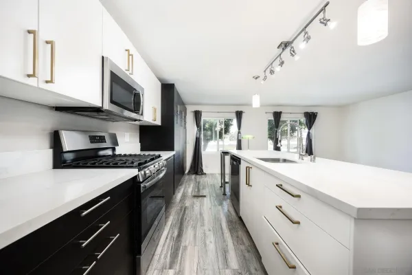 a large kitchen with a stove top oven