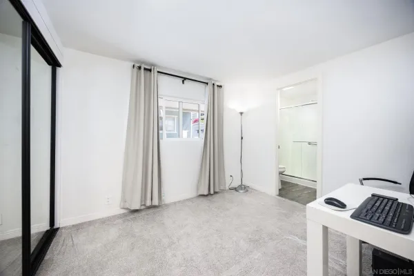 a white toilet sitting next to a shower