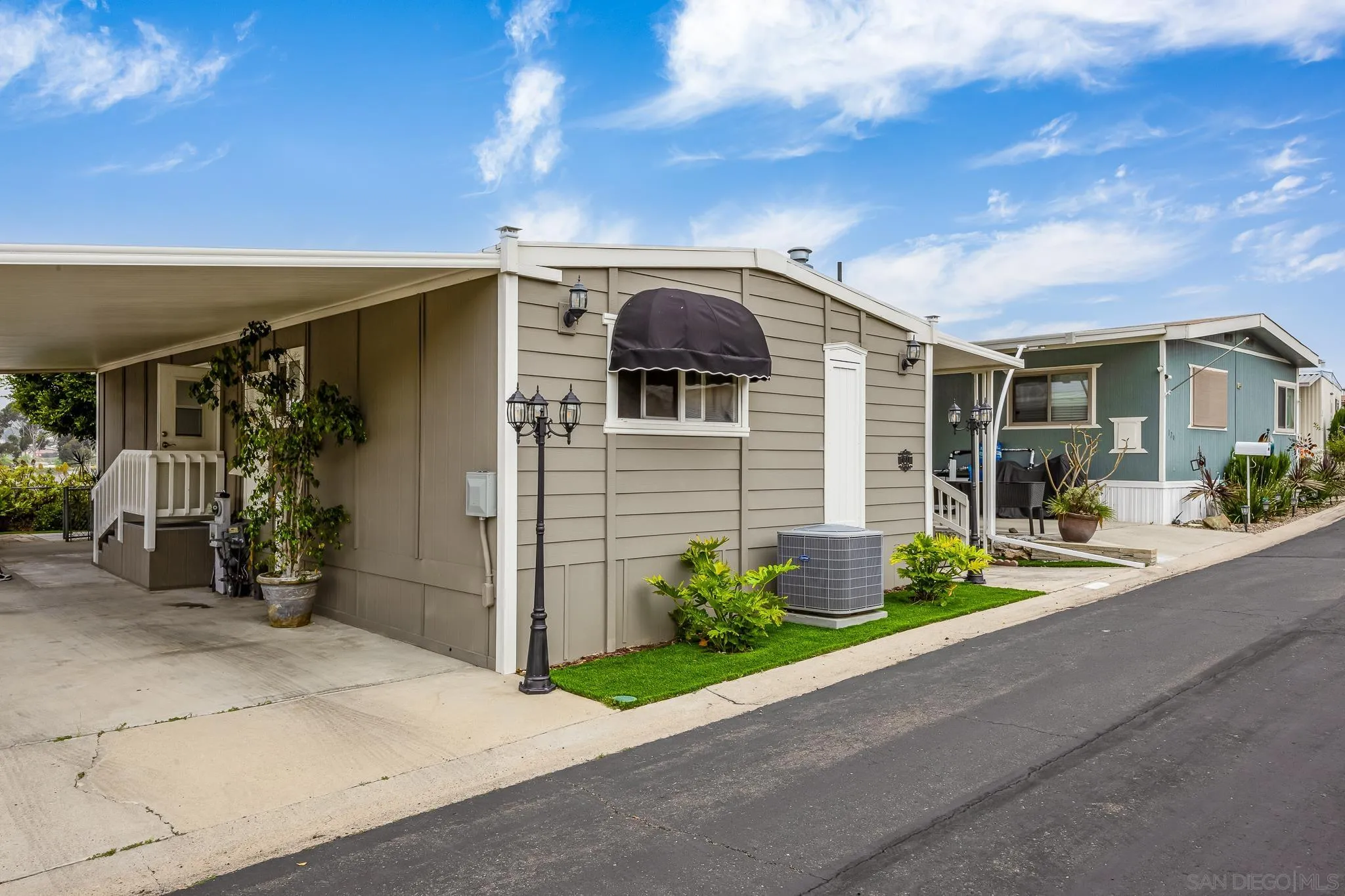 1815 Sweetwater Road, Unit SPC 121 Spring Valley, CA 91977 - Photo 3 of 44 a front view of a house with a yard