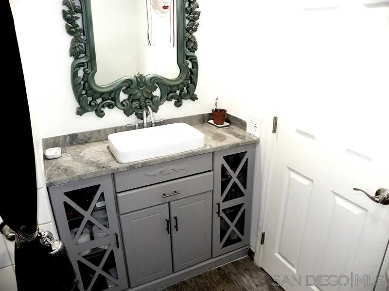 1815 Sweetwater Road, Unit SPC 121 Spring Valley, CA 91977 - Photo 35 of 44 a bathroom with a sink and a mirror
