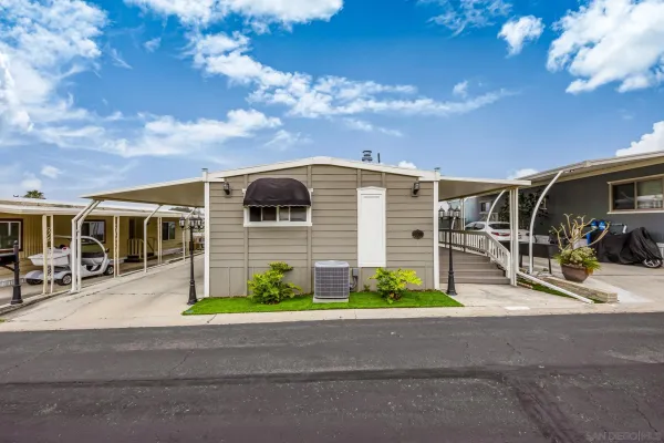 a view of a porch with furniture and a yard