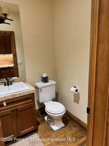 a bathroom with a toilet and a mirror
