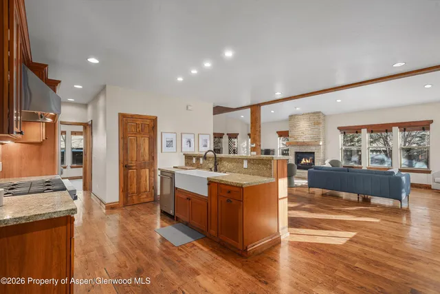a large kitchen with stainless steel appliances kitchen island granite countertop a large counter top and stove