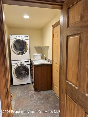 a utility room with sink dryer and washer