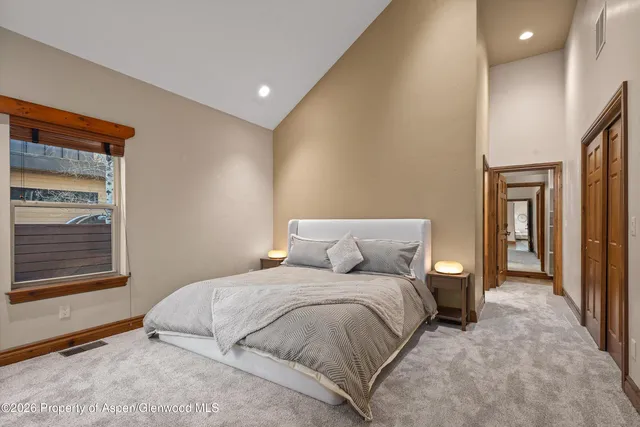 a bedroom with a large bed and a window