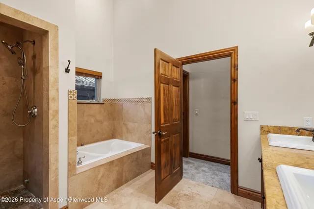 a bathroom with a tub and a shower