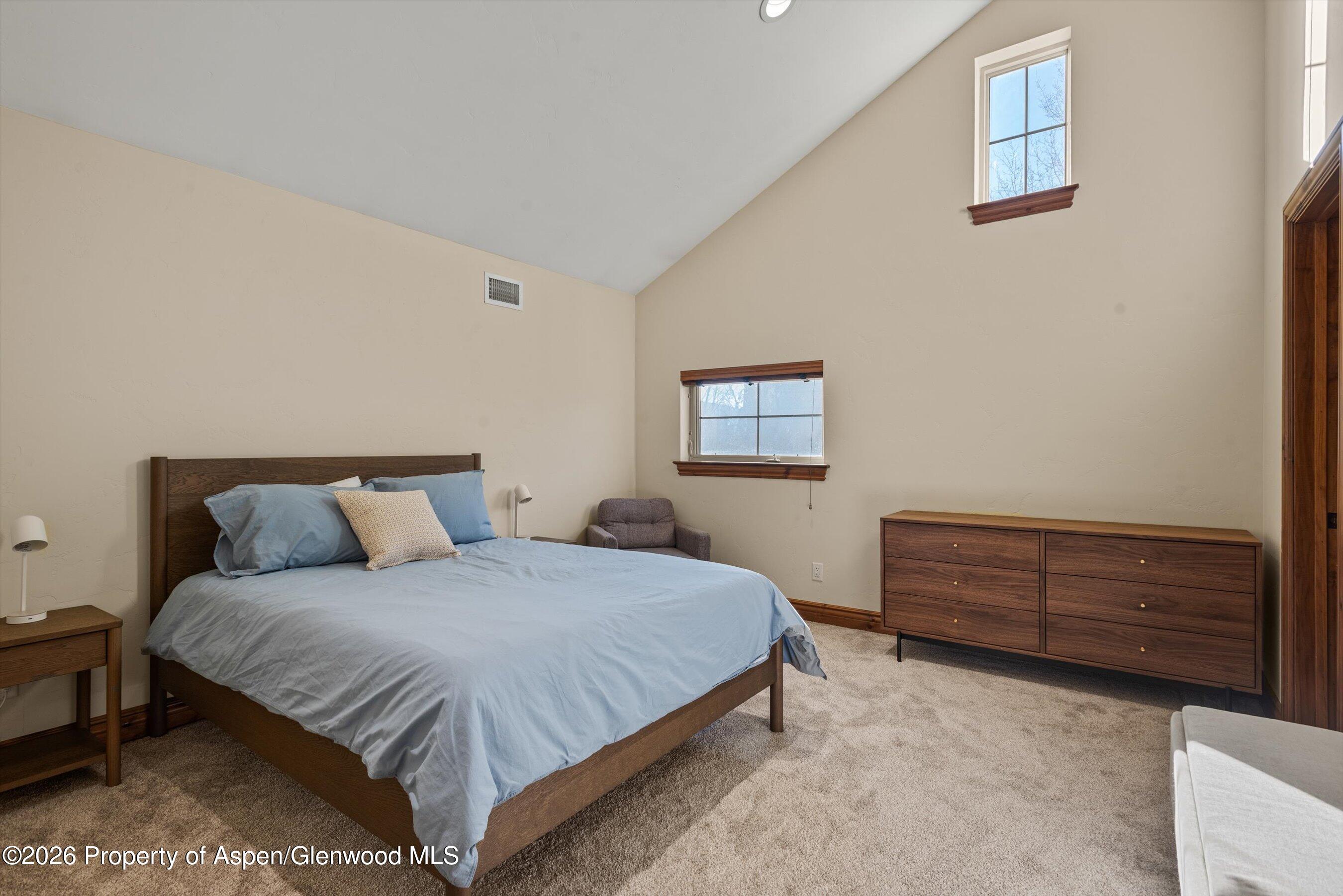 225 Juniper Court Basalt, CO 81621 - Photo 18 of 30 a bedroom with a bed and a dresser