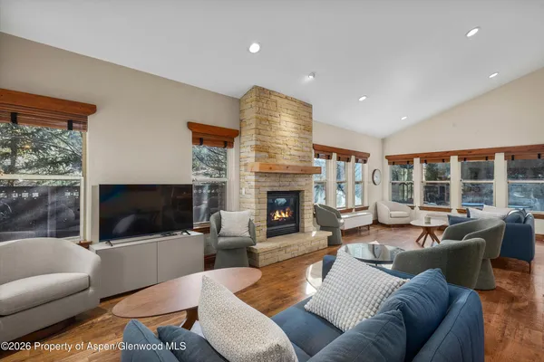 a living room with furniture fireplace and flat screen tv