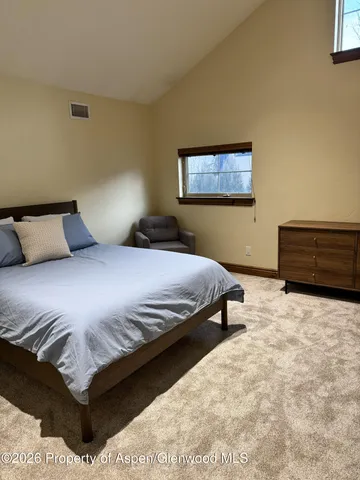 a bedroom with a bed and window