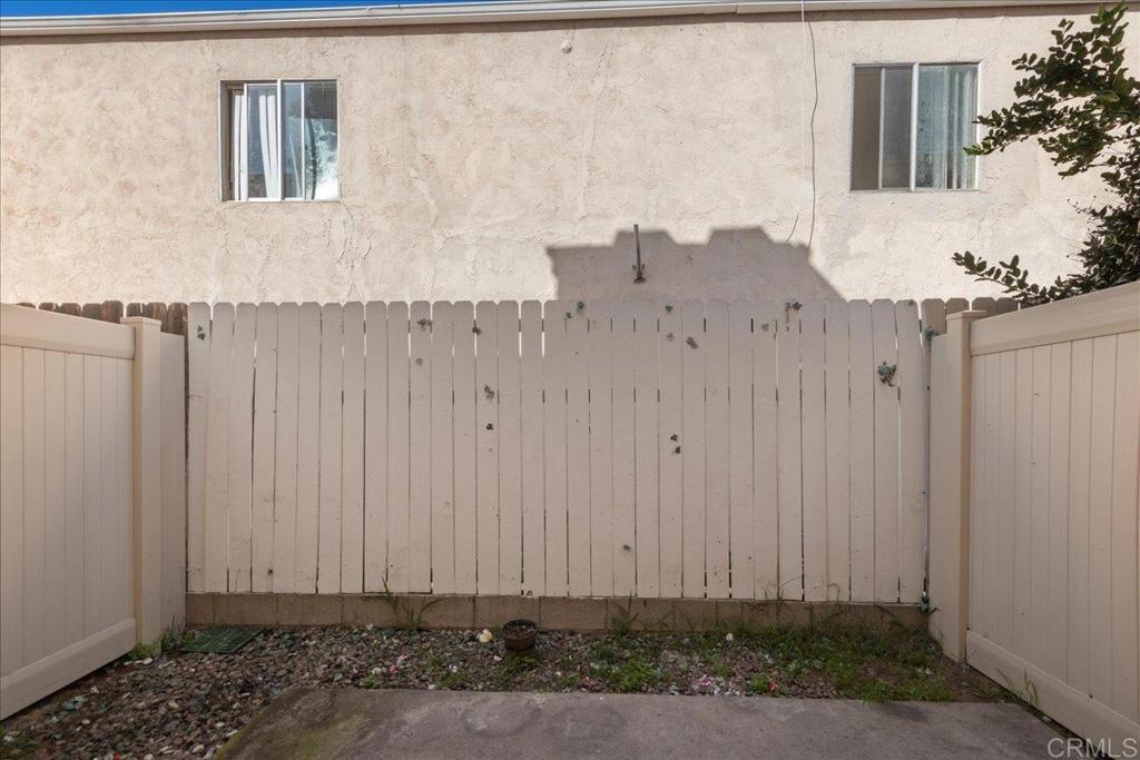 389 Shady Lane, Unit D El Cajon, CA 92021 - Photo 14 of 30 a view of a house with a wooden fence