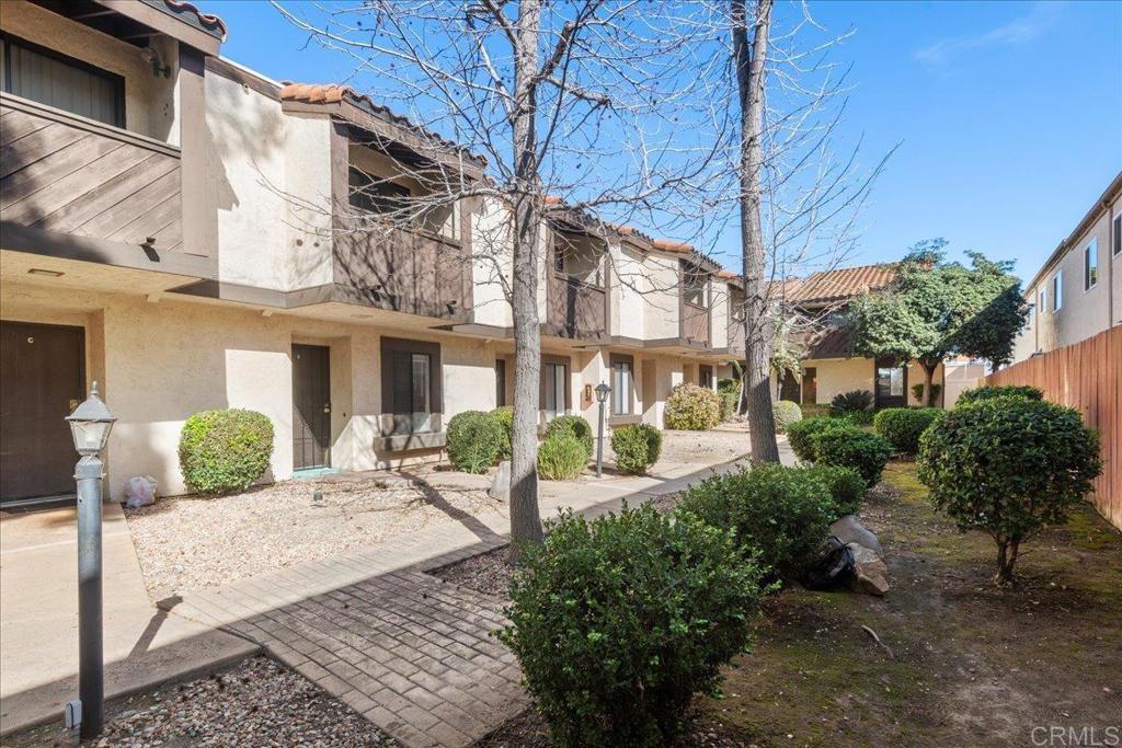 389 Shady Lane, Unit D El Cajon, CA 92021 - Photo 4 of 30 a front view of a building with garden