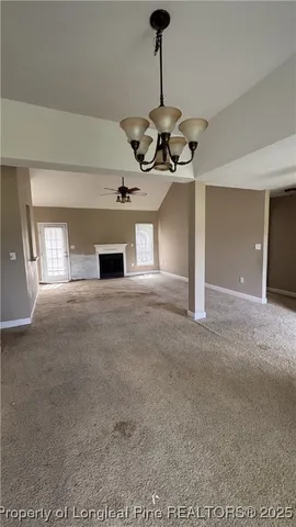a view of a room with a ceiling fan