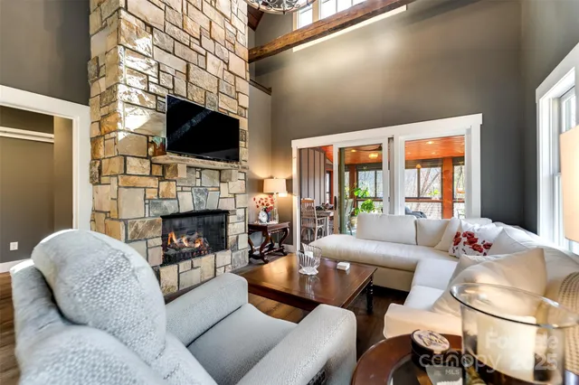 a spacious bedroom with a bed chandelier and a window